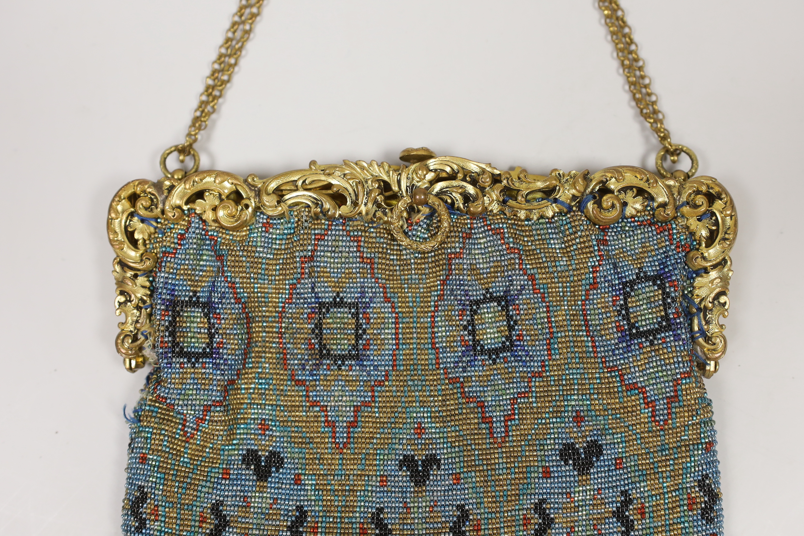 A late 19th century French gilt metal mounted coloured beaded evening bag, 17cm wide